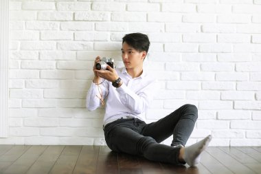 Asyalı genç adam studi bir kamera kullanır