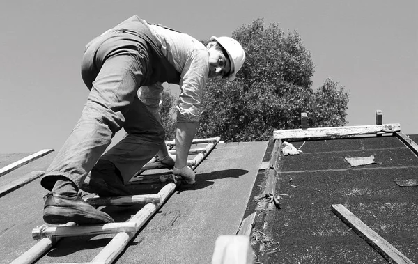 İnşaat alanında işçi kıyafetleri giyen bir adam.