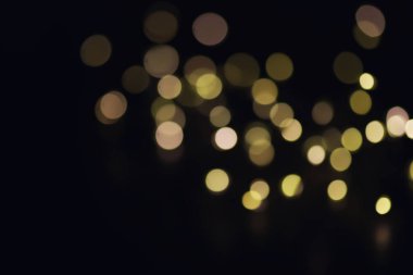Soyut bokeh arkaplanı. Koyu mavi arka planda altın bokeh daireler çiziyor. Katman kaplaması.