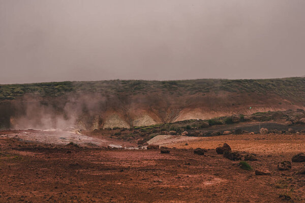 Empty geothermal Krysuvik area on Reykjanes peninsula in Iceland on early summer morning. Visible sulphur rising from the ground.