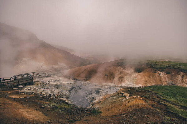 Empty geothermal Krysuvik area on Reykjanes peninsula in Iceland on early summer morning. Visible sulphur rising from the ground.