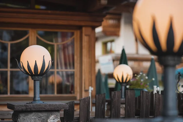 Light or ornament on a garden of a restaurant. Round lamps in flower petal shape as a decorative light on a beer garden.