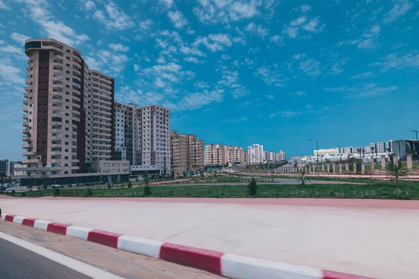 Residental buildings in the city of Oran, Algeria with some large skyscrapers dominating the skyline on a sunny day.