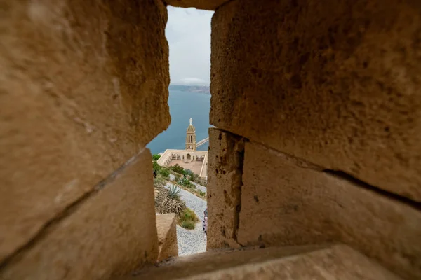 Panoramic view of blessed virgin mary church from Santa Cruz fortress, one of the three forts in Oran, the second largest port of Algeria; Summer day, looking from high above towards the city.