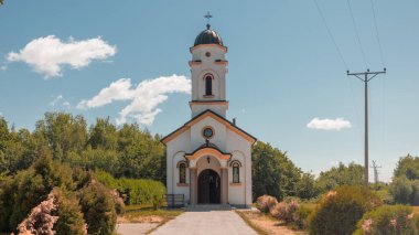 Orthodox church in northern Bosnia on a sunny morning. Typical orthodox church on green meadows and blue skies.