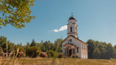 Orthodox church in northern Bosnia on a sunny morning. Typical orthodox church on green meadows and blue skies.