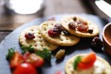Aperatifler ve atıştırmalıklar, krakerler, kurutulmuş meyve, domates ve maydanoz.