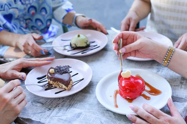 Tasty deserts and ice cream. Girls and boys holding deserts. Delicious decorated deserts on plates