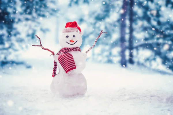 Cheerful snowman with orange scarf and in yellow boots stands upside down in winter — Stock Fotó