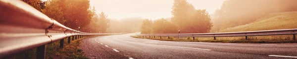 Black Asphalt Road Dividing Line Safety Fence Morning Mist Highway — Φωτογραφία Αρχείου