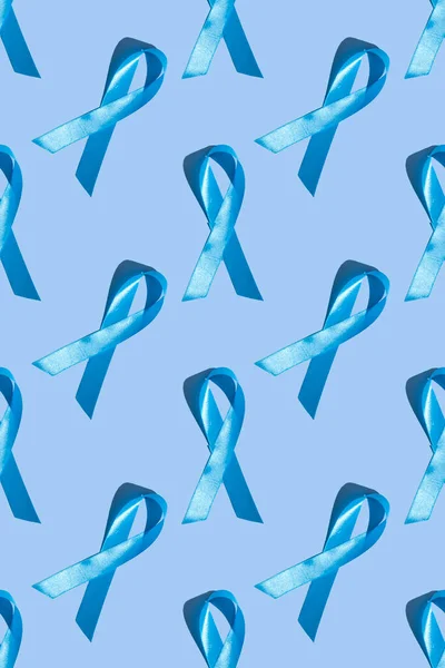 Concept for world diabetes day 14 november. Symbolic color bow to raise awareness on the day of diabetes on a light background. Seamless pattern. Vertical photo