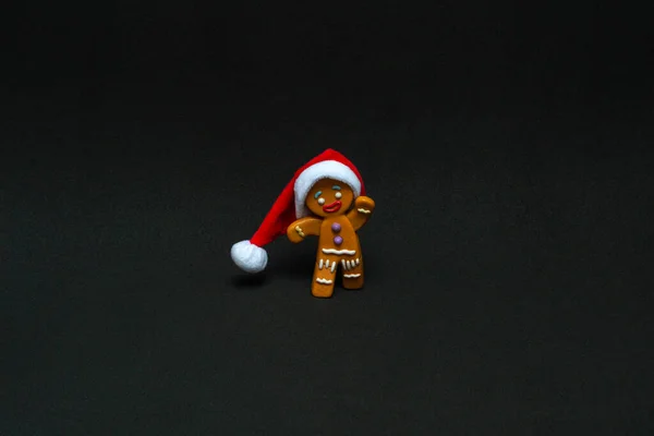 Christmas Concept Gingerbread Man Santa Hat Black Background Copy Space — Stock Photo, Image