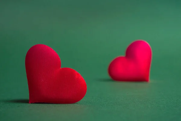 stock image Composition for Valentine's Day. On a green background, red hearts close up with copy space