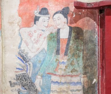 NAN-THAILAND  DECEMBER 26 : Grandfather and Grandmother's curtain painting in Wat Phumin Which is a picture of whispering to love each other on DECEMBER 26 2020 in Nan, Thailand.