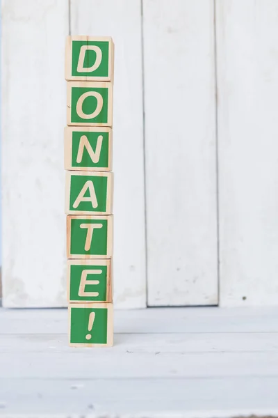 Wooden cube, with the word donate, on white background — Stock Photo, Image