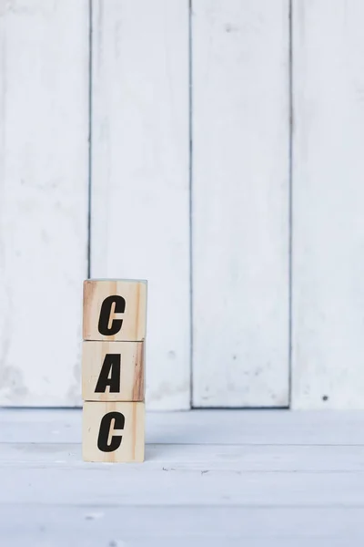 cac kavramı tahta küplere ya da bloklara, beyaz ahşap arka plana yazılmıştır..