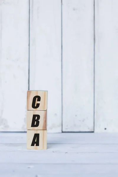 Conceito cba escrito em cubos ou blocos de madeira, sobre fundo de madeira branco. — Fotografia de Stock