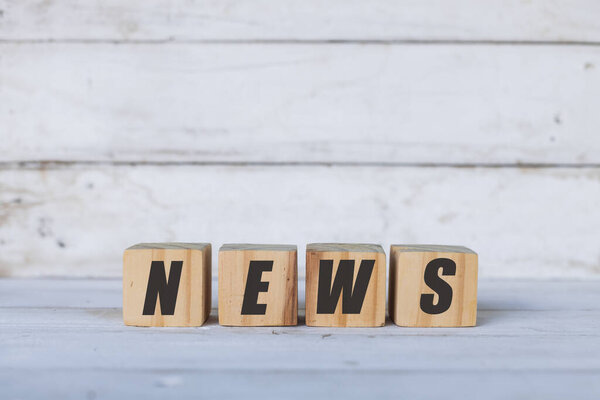 новостная концепция написана на деревянных кубиках или блоках, на белом деревянном фоне.