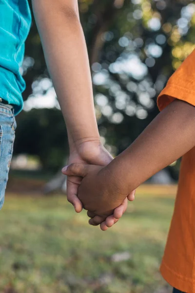 Two children holding hands in the forest, brothers together, — Stock Photo, Image