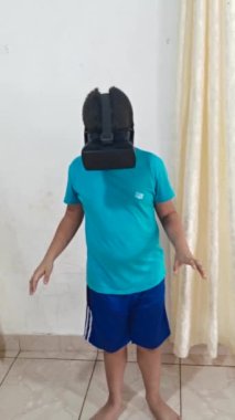 Mavi kazaklı Latin çocuk sanal gerçeklik gözlüğü takıyor, genel uçak.,
