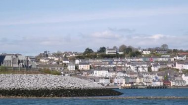 View on Cobh city from boat, waterside view, houses and St. Colmans Cathedral, Cobh, Ireland. High quality 4k footage