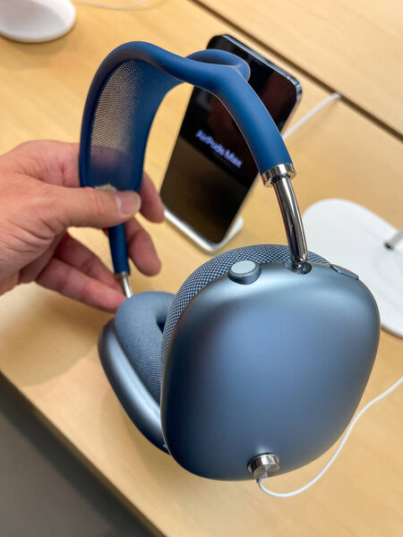 Кёльн, Германия - 01 октября 2021: Немецкий фотограф сравнивает и тестирует новый Airpod Max в разных цветах в Apple Store.