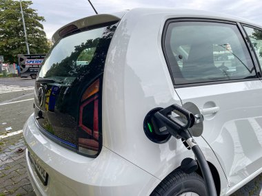 Limburg, Almanya - 30 Eylül 2021: Alman bir fotoğrafçı elektrikli bir arabayı test ediyor, 3ncü otoyoldaki bir otoparkta yüklüyor..