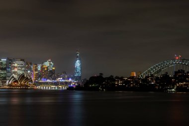 Sydney, Avustralya - 10 Şubat 2020: Avustralya 'da Sydney' i ziyaret eden bir Alman fotoğrafçı, yazın bulutlu ama sıcak bir günde Opera binasıyla ufuk çizgisinin fotoğraflarını çekiyor.