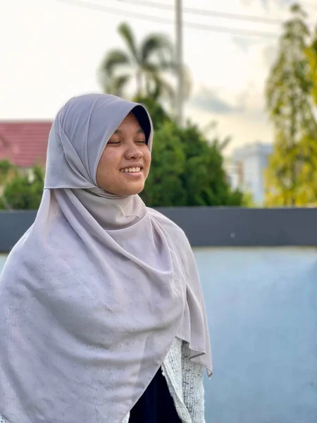 Gülümseyen tesettürlü küçük bir kızın portresi