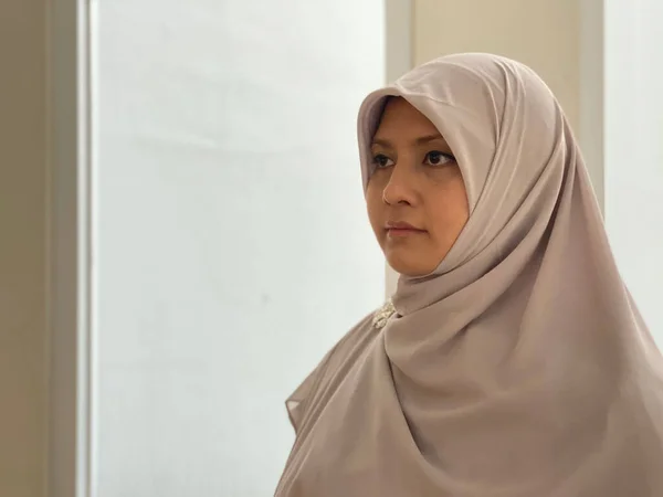 Portrait young woman wearing hijab looking away