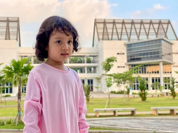 Portrait of a little girl wearing pink dress