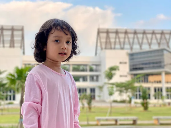 Portrait of a little girl wearing pink dress