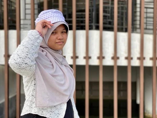 Portrait teenage asian girl wearing hijab and hat