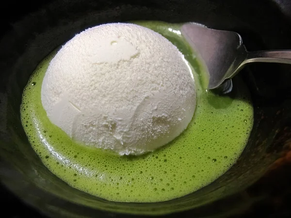 Close up Coconut ice cream in matcha green tea served in a dark bowl, famous Japanese matcha dessert menu