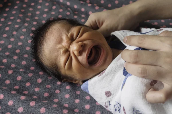 newborn baby boy crying after bathing at children\'s bedroom in the morning. family, love and life concept.