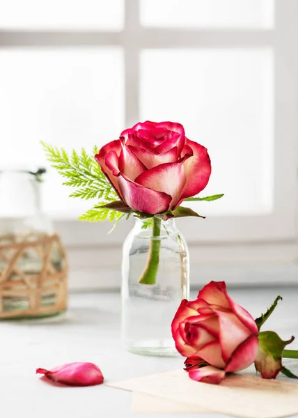 窓の近くのガラス花瓶に夏の赤いバラの花束 花はまだヴィンテージスタイルで生きています フロリスティックまたはホームデココンセプト 選択的焦点 — ストック写真