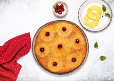 Fresh baked pineapple upside down cake with candied cherries and caramel. Homemade sweet food concept. Flat lay. Copy space.