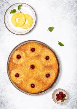 Delicious pineapple upside down cake with candied cherries. Summer tropical dessert. Top view. Copy space.