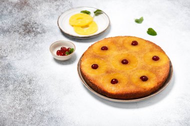 Fresh baked pineapple upside down cake with glace cherries. Delicious homemade sweet food concept. Selective focus. Copy space.