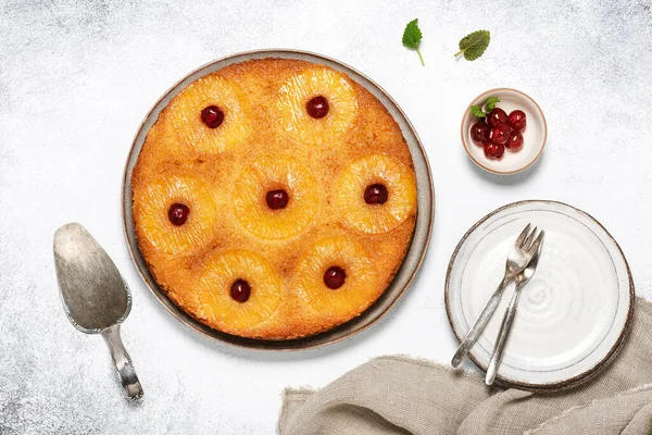 Fresh baked pineapple upside down cake with candied cherries and caramel. Flat lay. Homemade sweet food concept. 