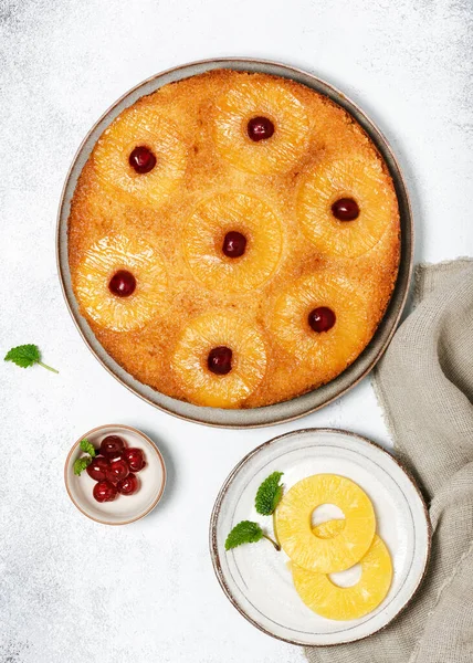 Delicious pineapple upside down cake with candied cherries. Homemade summer tropical dessert. Flat lay.