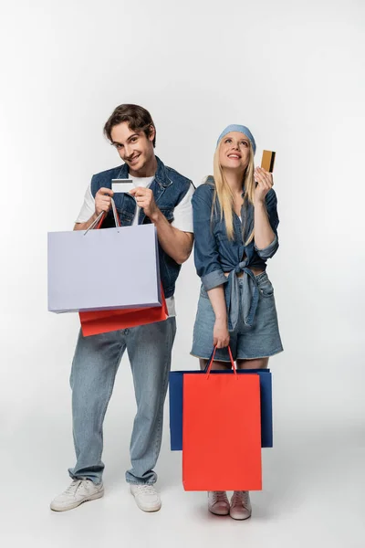 Stylish Couple Denim Clothes Posing Shopping Bags Credit Cards White — Stock Photo, Image