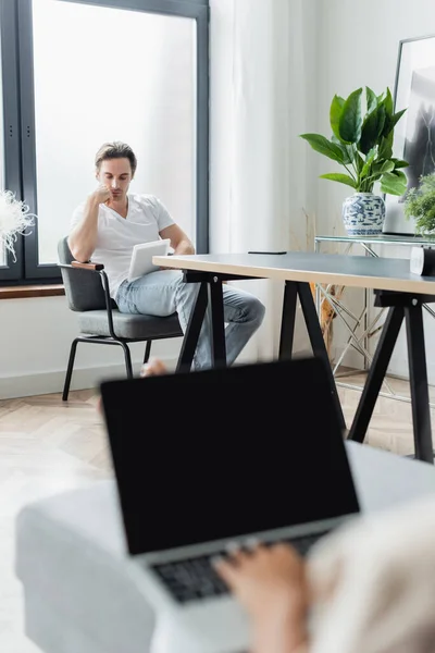 Hombre Usando Tableta Digital Cerca Borrosa Novia Escribiendo Ordenador Portátil — Foto de Stock