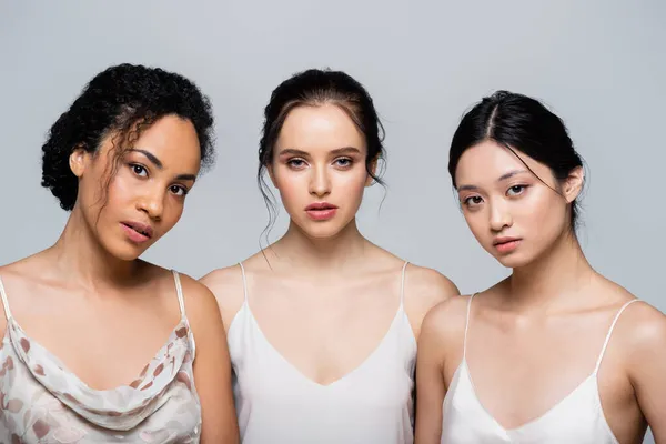 Csinos Többnemzetiségű Nők Tökéletes Bőr Nézi Kamera Elszigetelt Szürke — Stock Fotó