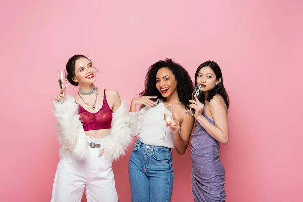 Positive Multiethnic Women Holding Champagne Glasses Isolated Pink — Stock Photo, Image