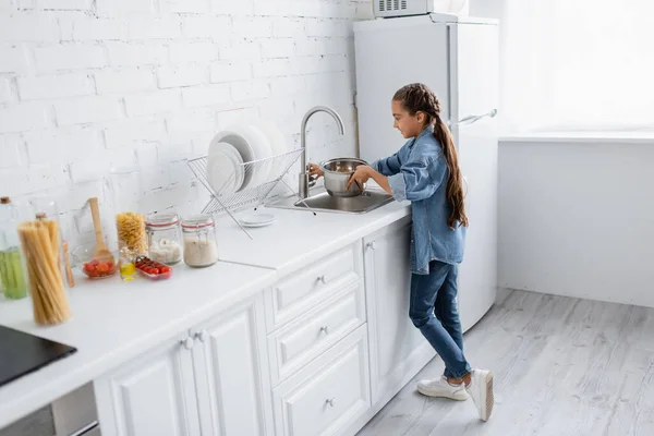 Side View Kid Pouring Water Saucepan Kitchen — Stock Photo, Image