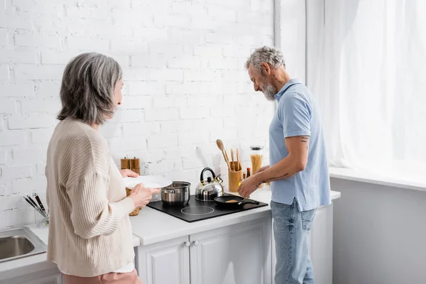 Mature Man Cooking Pancake Wife Plate Kitchen — Stock Photo, Image