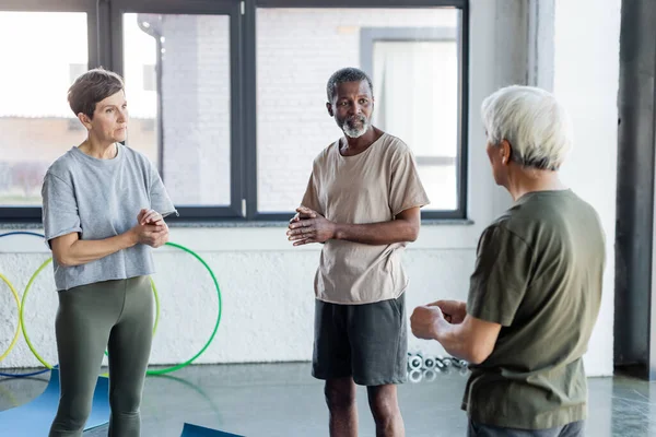 Multietniska Äldre Människor Värmer Upp Och Tittar Vän Gymmet — Stockfoto