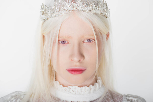 Portrait of albino woman in crown with pearls isolated on white