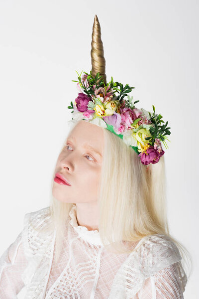 Portrait of albino woman in wreath with flowers and horn isolated on white